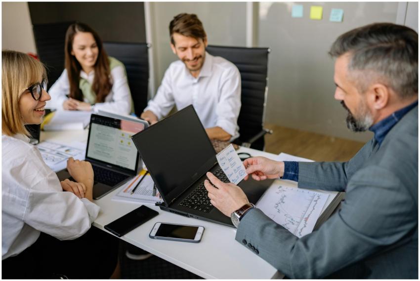 Business team discussing strategies with laptops a