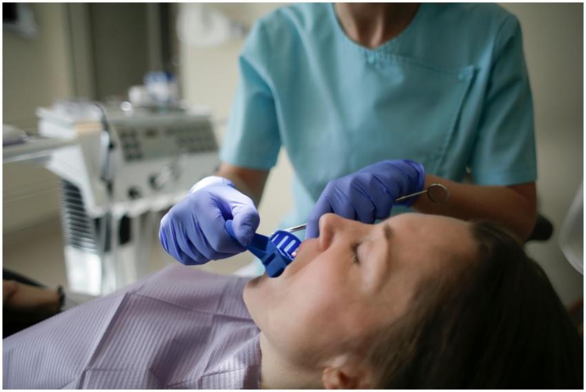 Crop anonymous female dentist in sterile gloves an