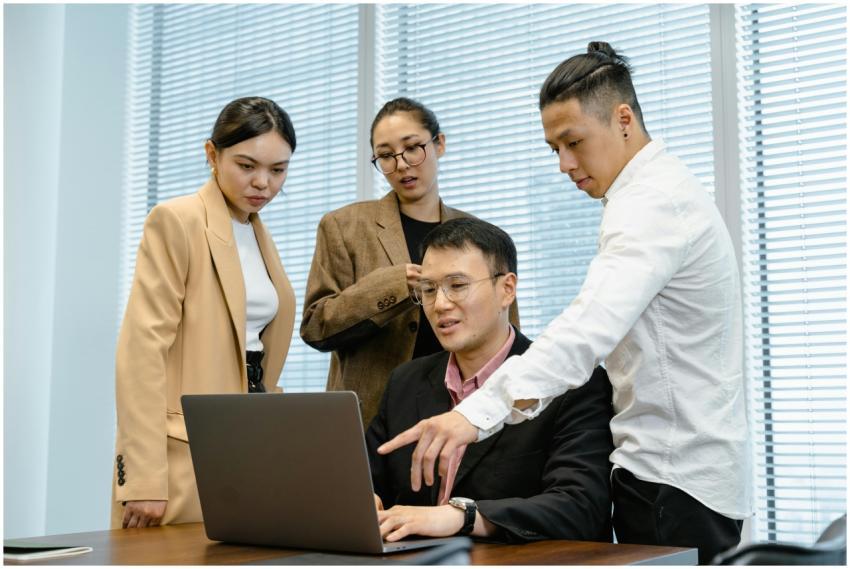 A group of professionals engage in teamwork around