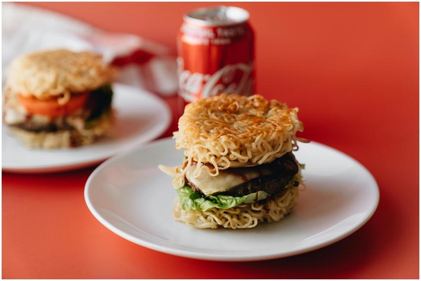 Delicious ramen burger on white plate with soda on