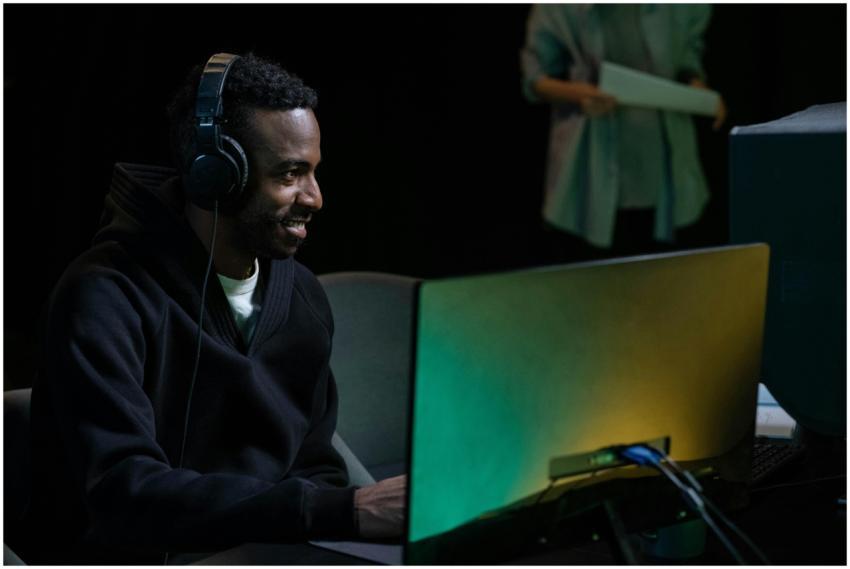 Smiling man in headphones working on audio product