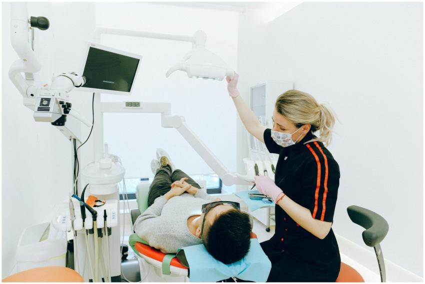 Female dentist examines patient's teeth in modern