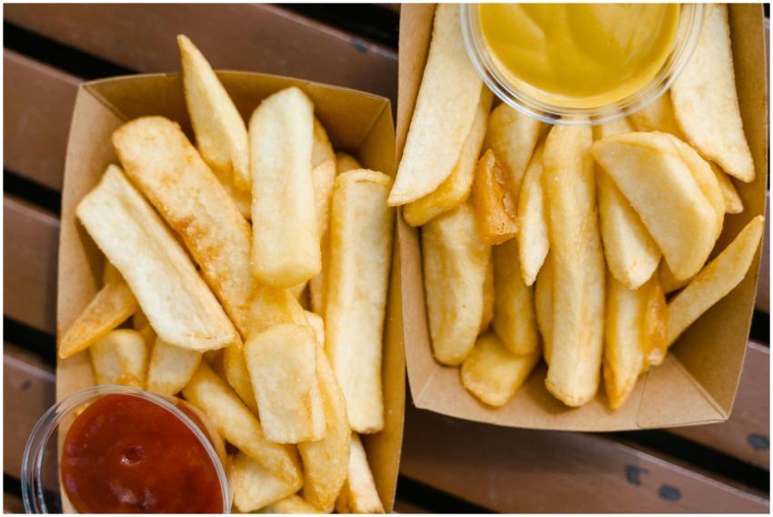Close-up of crispy french fries served with ketchu