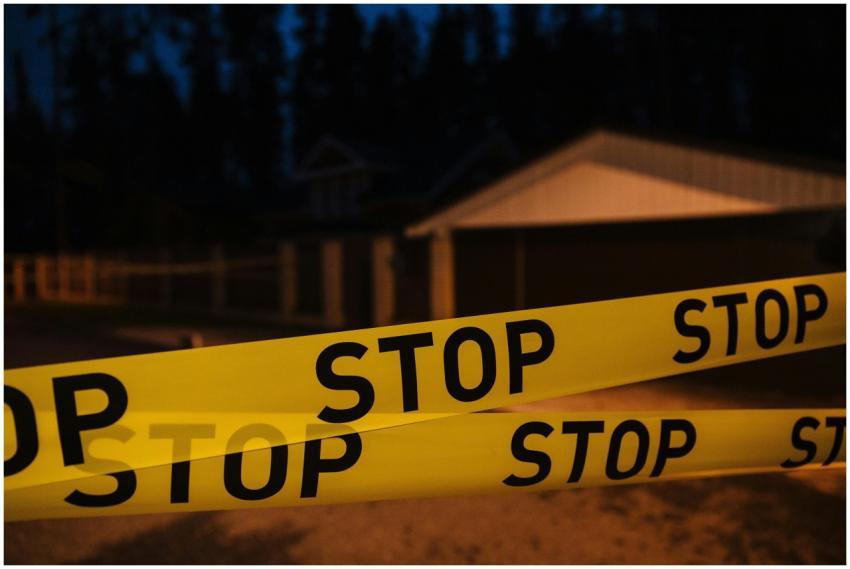 Yellow stop tape blocking a residential street at