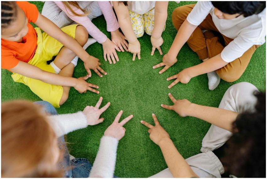 Children sitting in a circle playing fun team game