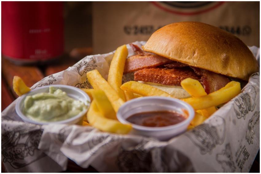 Close-up of a savory bacon cheese burger served wi