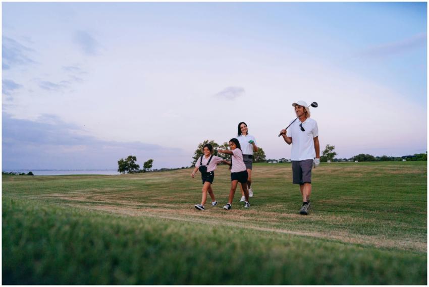 A family enjoys bonding while walking on a golf co