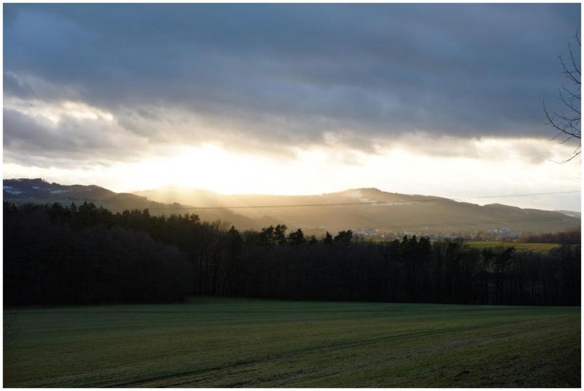 A beautiful sunrise illuminating hills and a lush