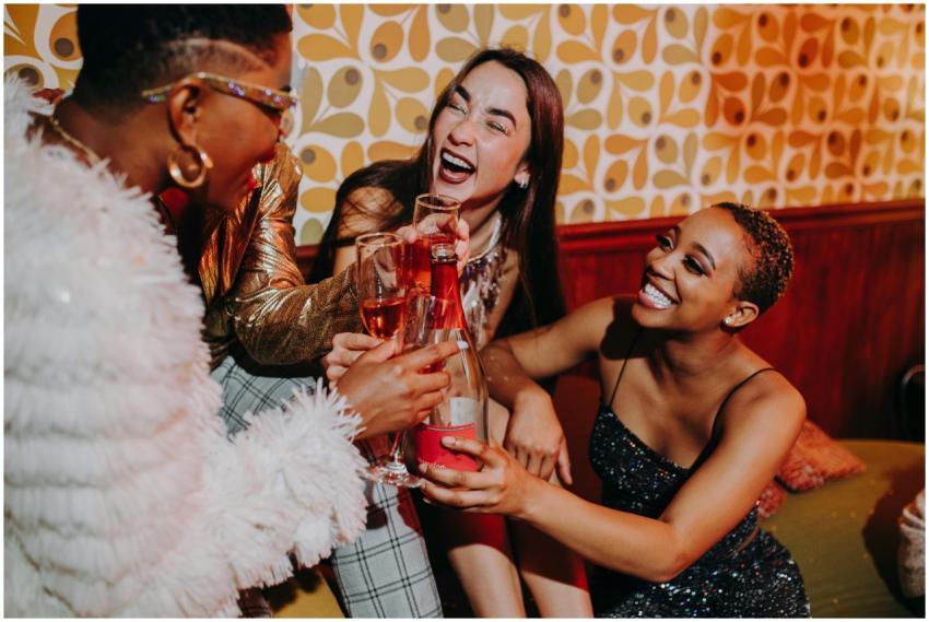 Three diverse women enjoying a lively indoor celeb