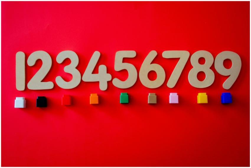 Wooden numbers with colorful cubes on a vibrant re
