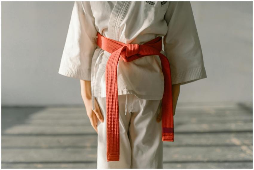 Close-up of a martial artist wearing an orange bel