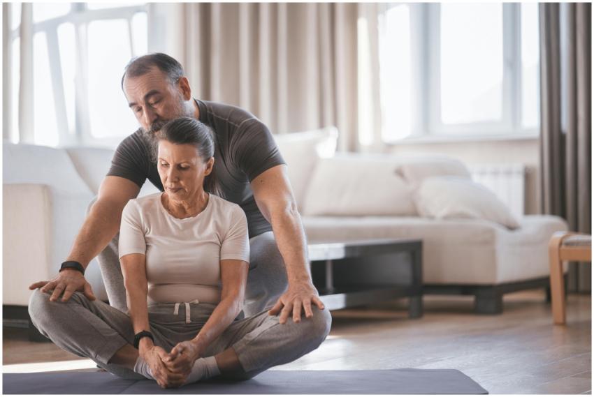 Elderly couple engaging in a yoga session indoors,