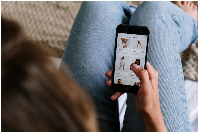 A woman uses her smartphone to shop for clothing o