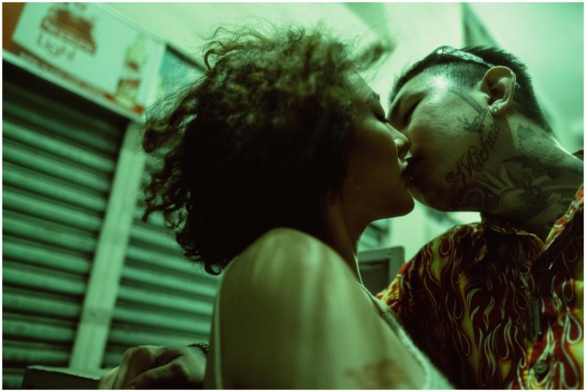 Close-up of a couple kissing in the city at night,