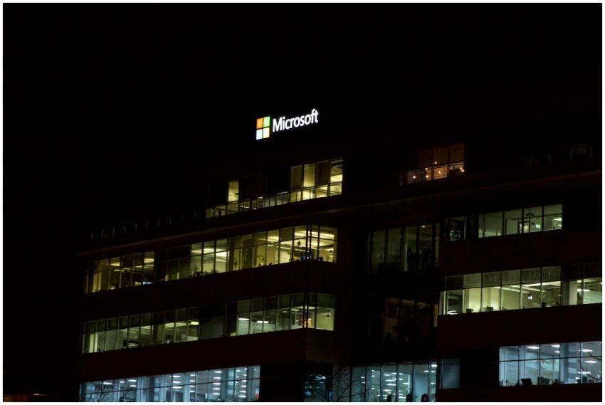 Nighttime view of a brightly lit modern office bui