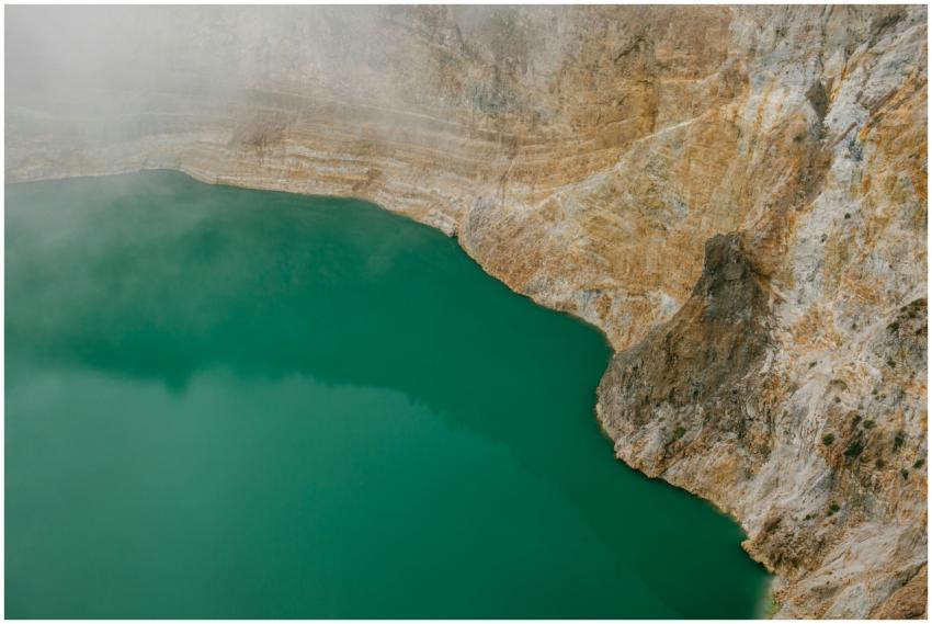 A mesmerizing aerial shot of a turquoise volcanic
