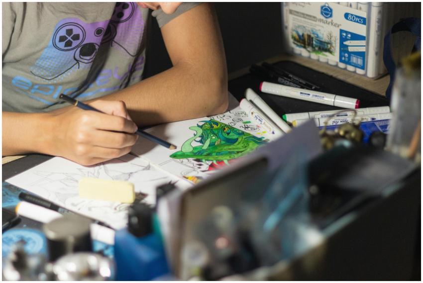 Close-up of an artist sketching a vibrant illustra