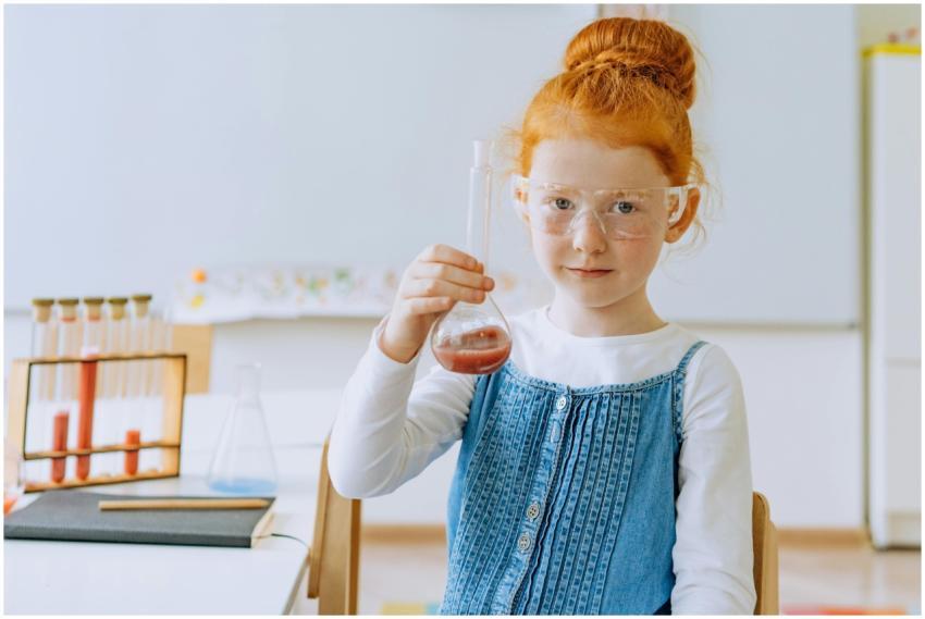 Girl in class conducting a science experiment with