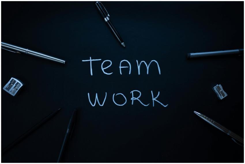 Arrangement of office supplies around teamwork tex