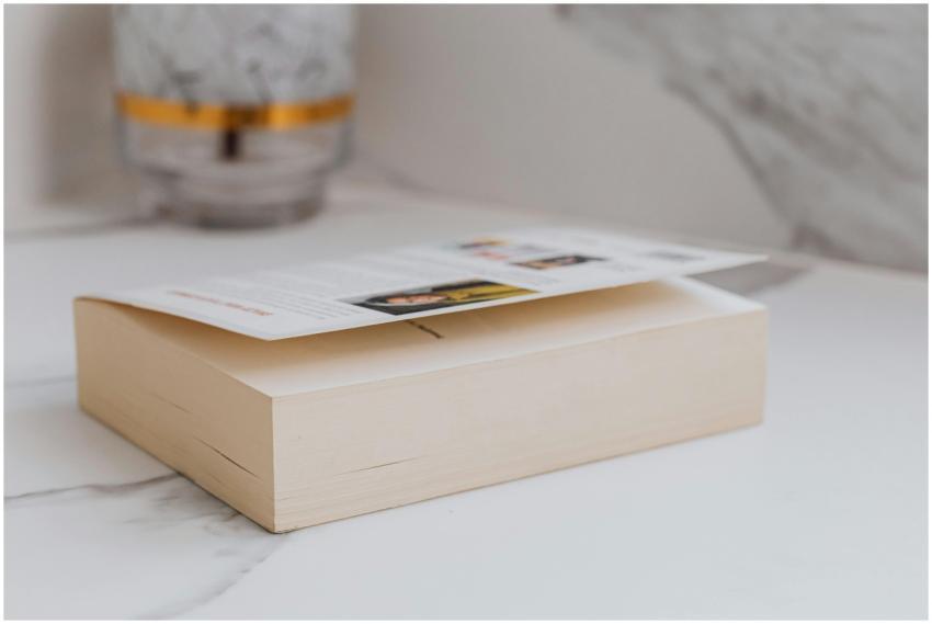 A minimalist close-up of a book placed on a marble