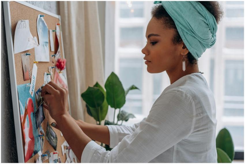Woman creating a vision board with images in a sty