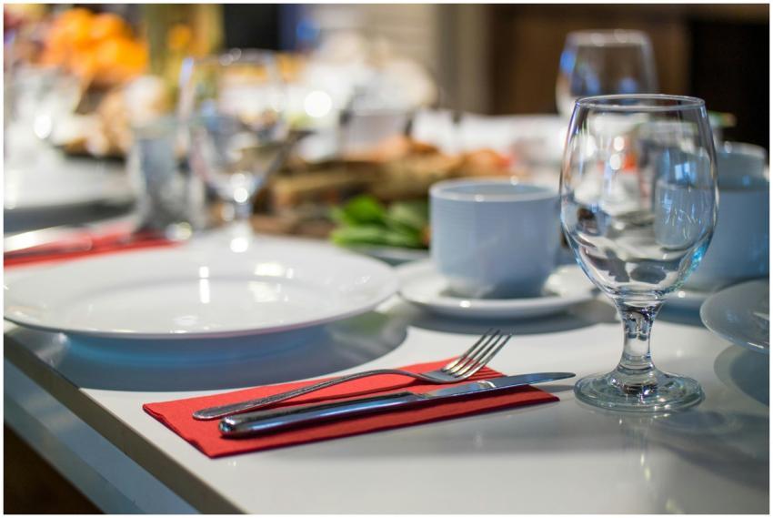 Close-up of an elegant dining table set with glass