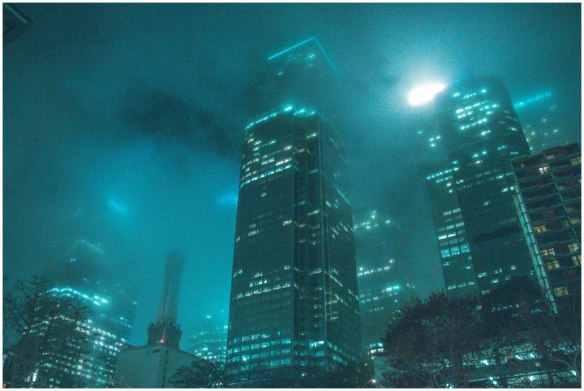 A dramatic cityscape view of skyscrapers shrouded