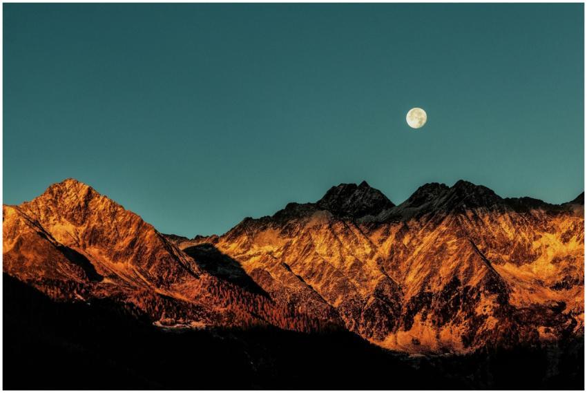 Breathtaking view of mountains with a full moon at