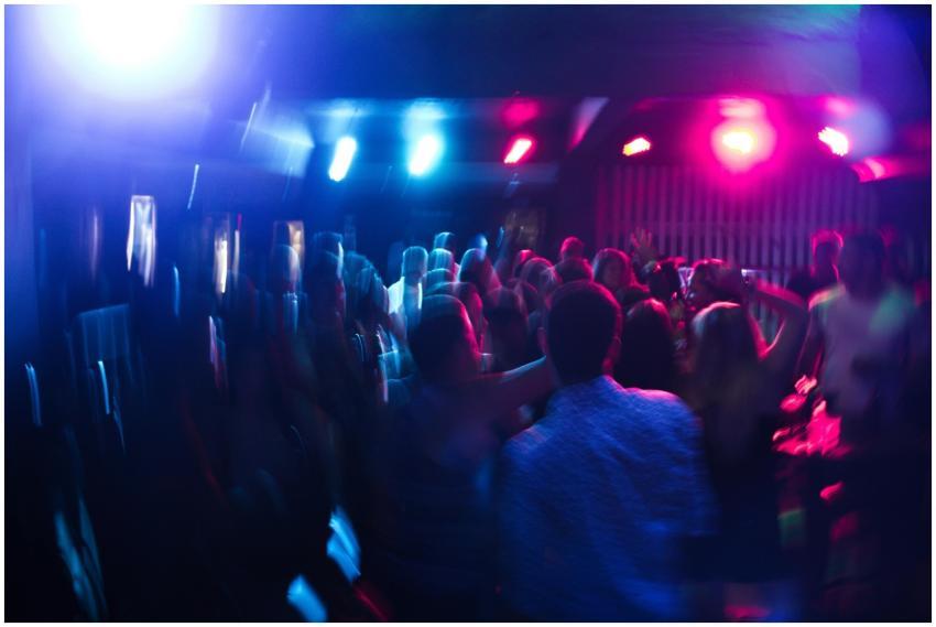 Vibrant nightclub scene with blurred dancing crowd