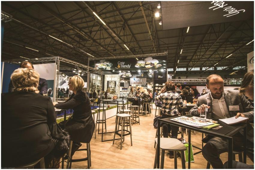 A bustling indoor business expo with professionals