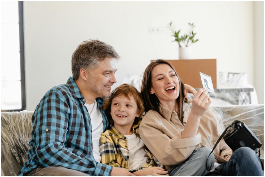 A cheerful family enjoys time together on a couch