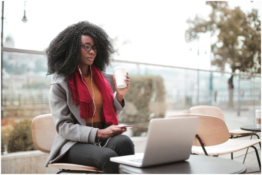 Confident woman working remotely in an outdoor caf
