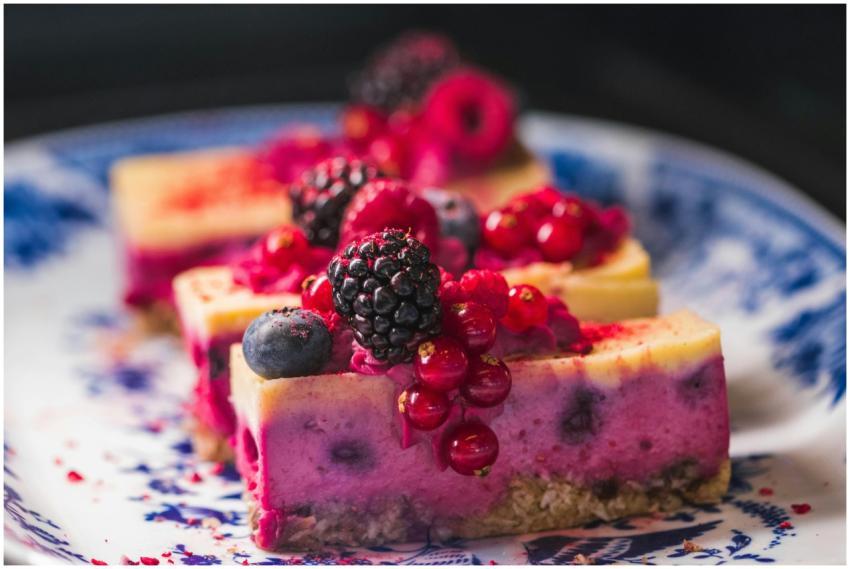 Sliced berry cheesecake topped with vibrant fresh