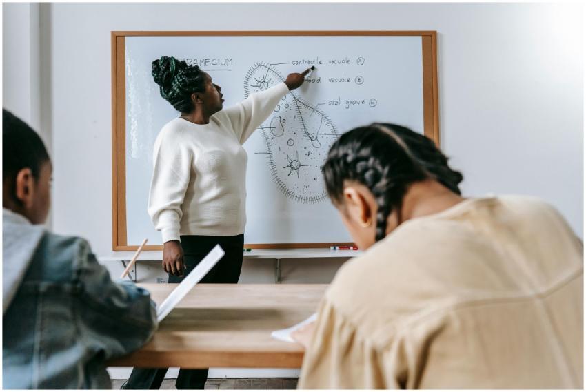 Smart diverse children writing in notebooks at tab