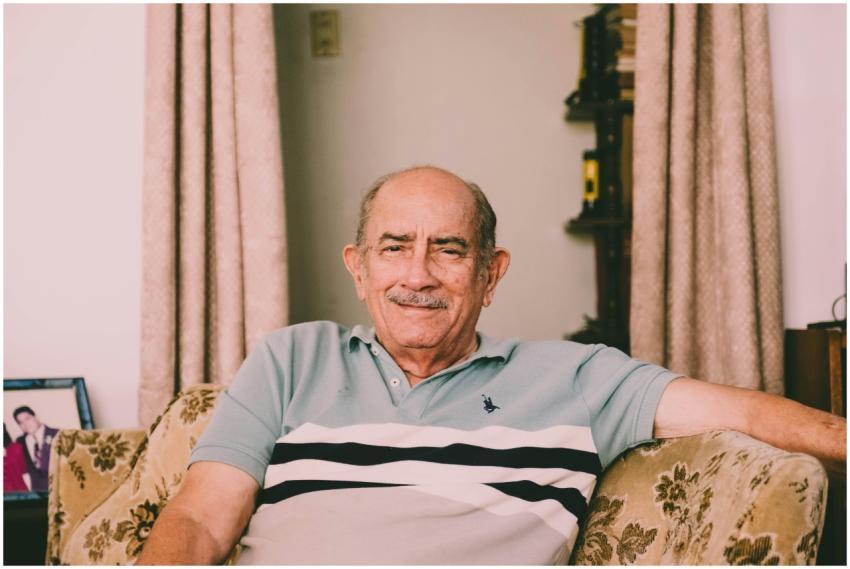 A cheerful elderly man enjoys a relaxed moment on