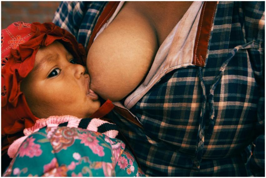 Close-up of a mother breastfeeding her baby, showc