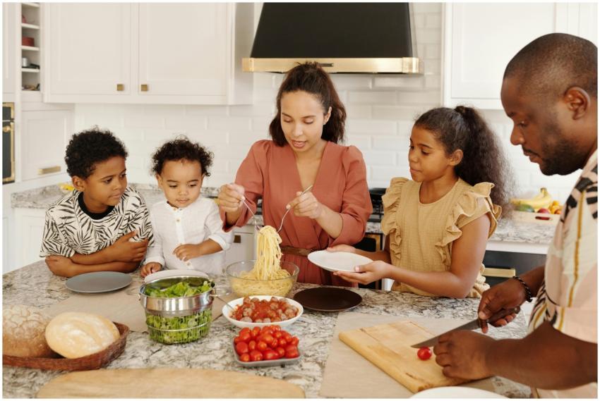 Family enjoying a cooking session together in a mo