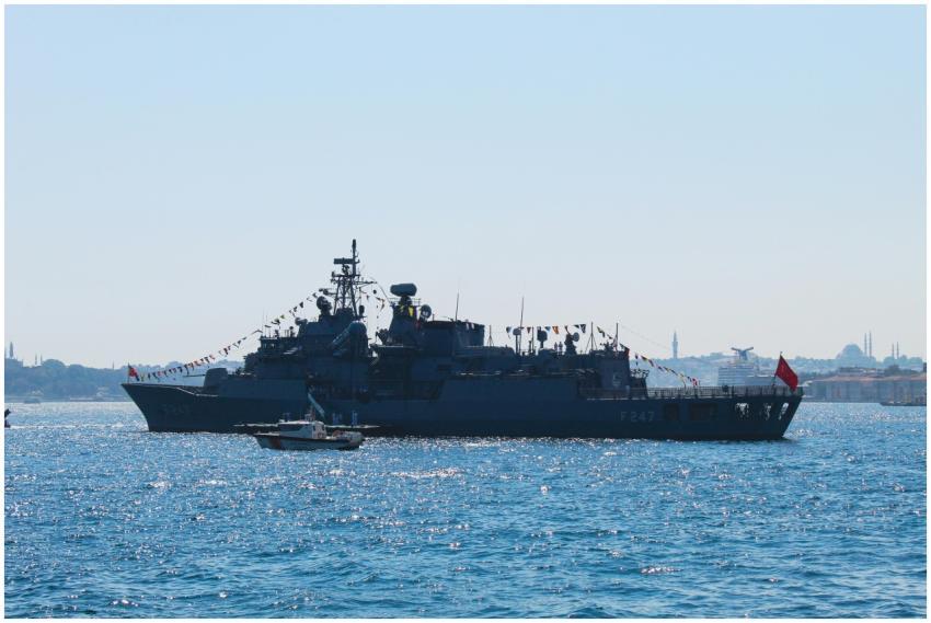 Navy ship on the Bosphorus with Istanbul skyline i