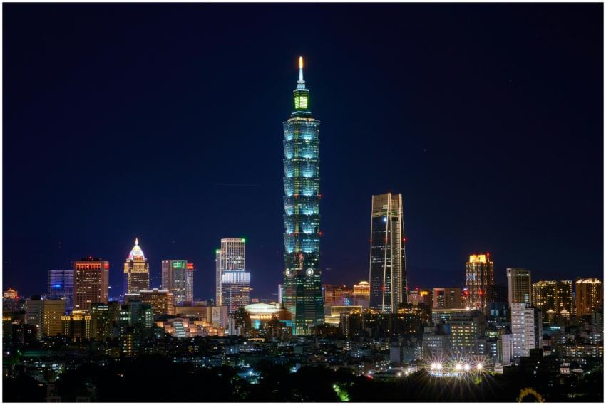 Illuminated Taipei 101 and city skyline at night s