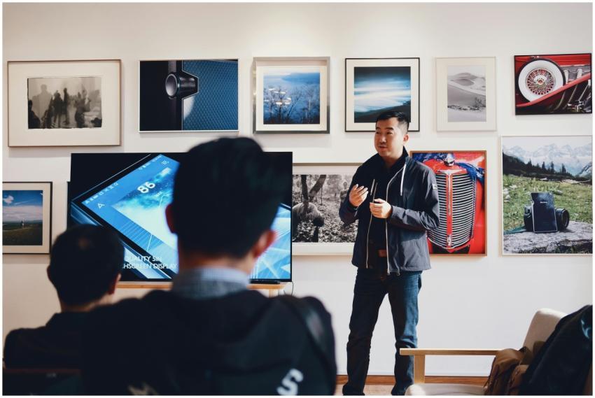 Man giving a presentation in a modern art gallery