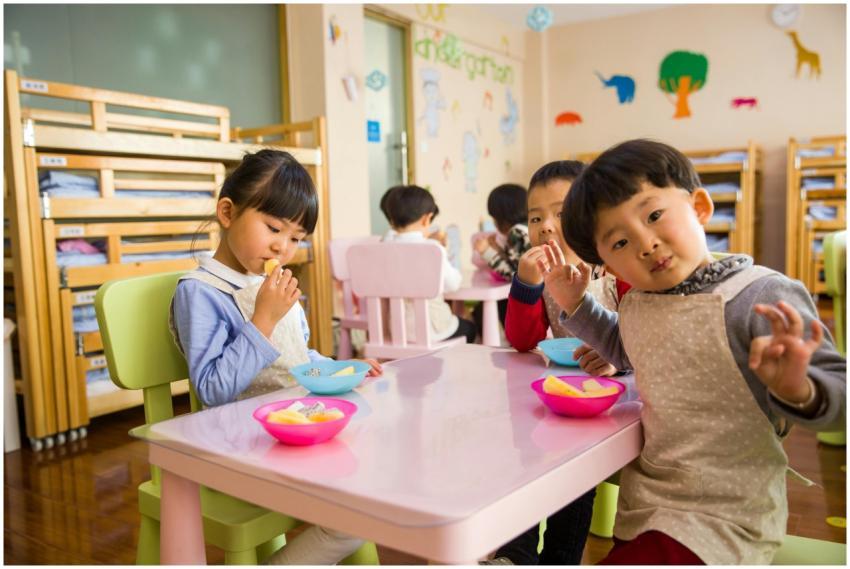 Kids seated around a table in a colorful classroom