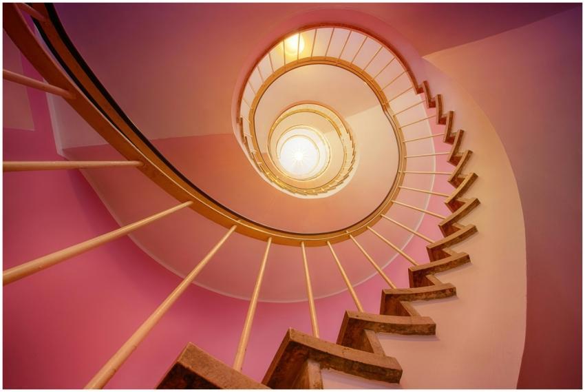 Stunning upward view of a spiral staircase with pi