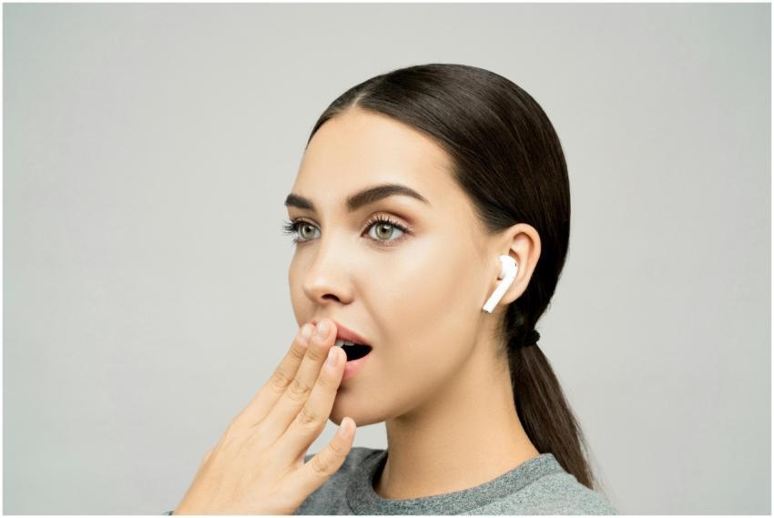 Portrait of a young woman with wireless earbuds, e