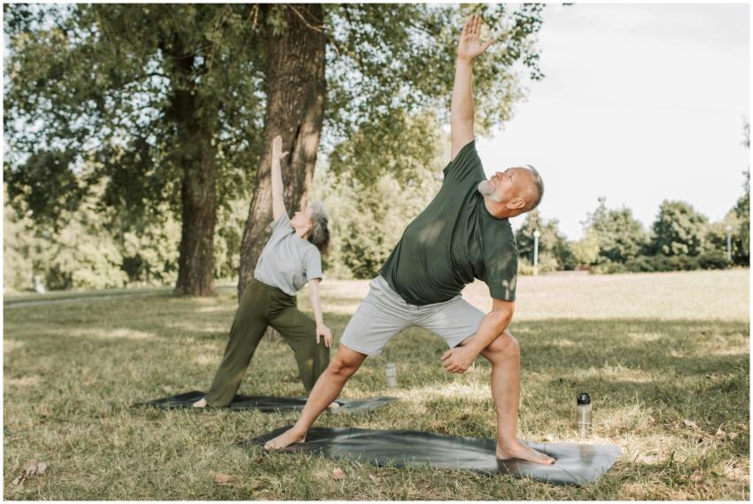 Senior couple enjoying yoga workout in the park, d