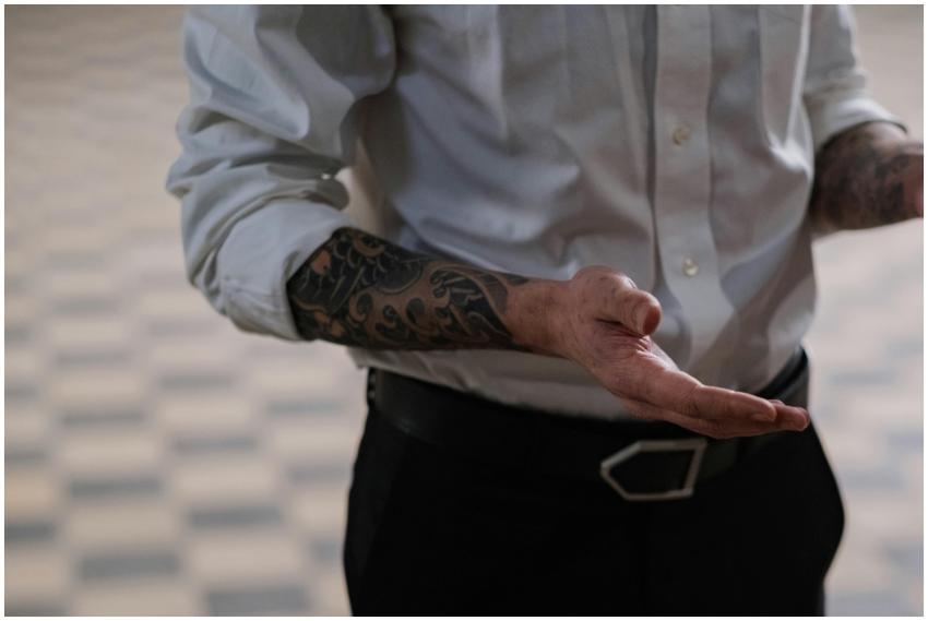 Close-up of tattooed hands in a white dress shirt