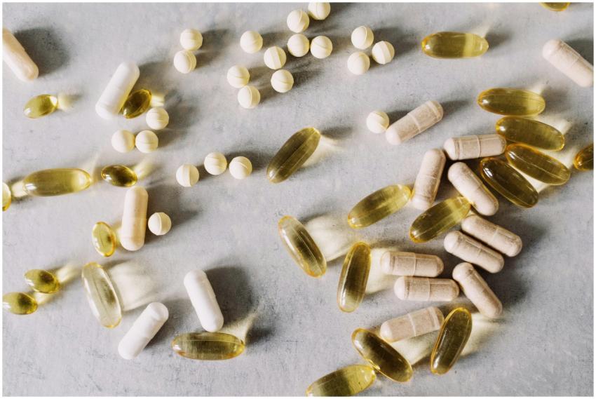 Various vitamins and supplements on a marble backg