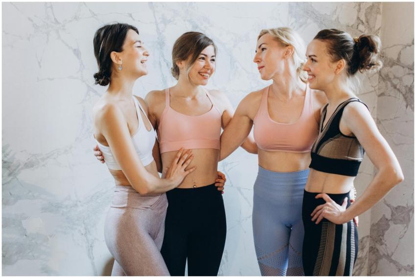 A group of cheerful women in activewear bonding in