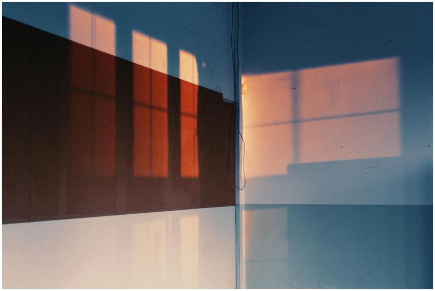 Artistic shadows of windows cast on a wall, creati