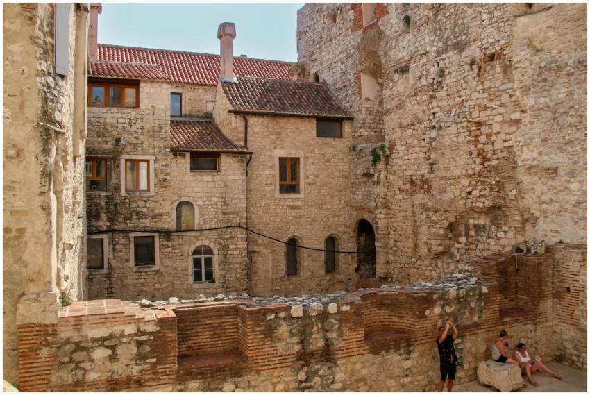 Ancient stone architecture with people in courtyar