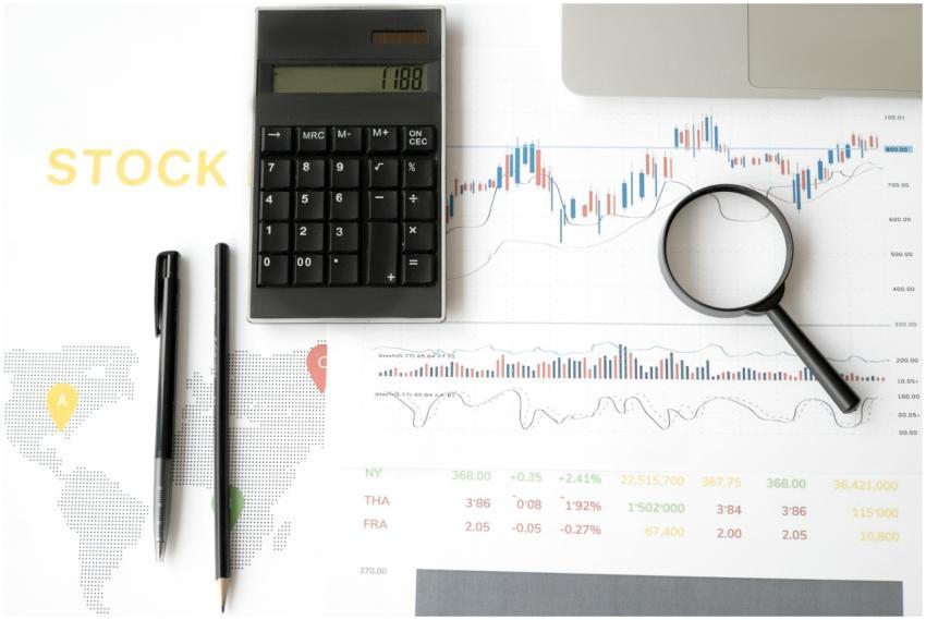 Flat lay of stock market analysis tools including